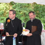 Fr. de Rosa presents Bishop Burbidge with a birthday cake.